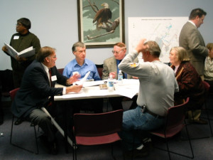 Group of individuals seated at a table at a planning meeting.